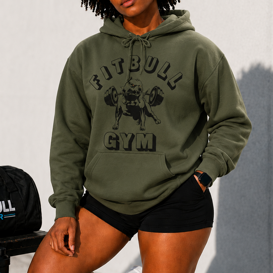 Person wearing a green 'FitBull Gym' hoodie with a bag and water bottle in the background.