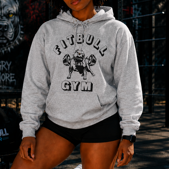 Person wearing a Fitbull Gym hoodie and shorts in an outdoor setting.