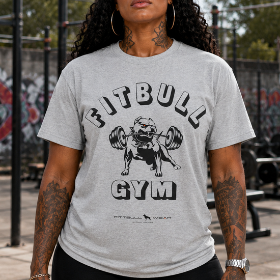 Woman wearing a gray 'Fitbull Gym' t-shirt outdoors.