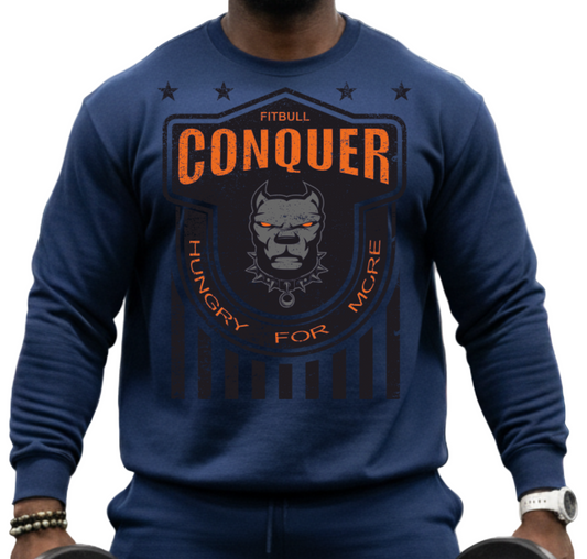 Man in Fitbull gym wearing a 'Conquer' shirt holding dumbbells