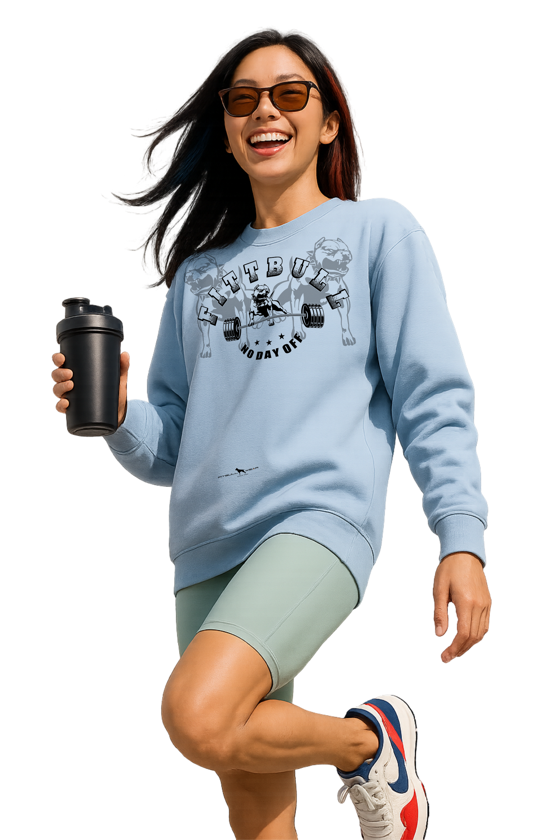 Woman in athletic wear with a blue Fitbull sweatshirt and green shorts, holding a black shaker bottle