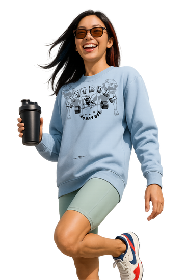 Woman in athletic wear with a blue Fitbull sweatshirt and green shorts, holding a black shaker bottle