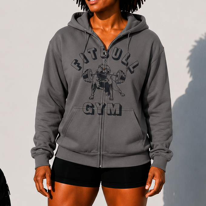 Person wearing a gray 'Fitbull Gym' hoodie with gym equipment in the background