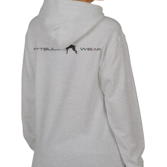 woman wearing grey sporty hoodie for fitness and bodybuilding training by the brand Fitbull, branded with a logo and a motivating motif side view