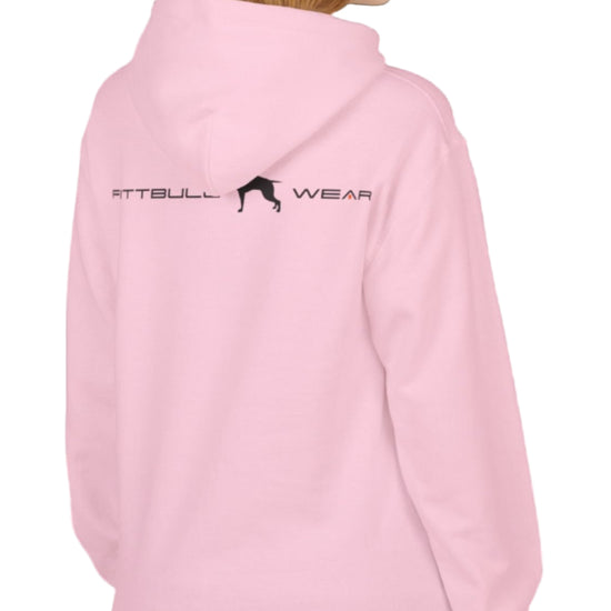 woman wearing pink sporty hoodie for fitness and bodybuilding training by the brand Fitbull, branded with a logo and a motivating motif side view