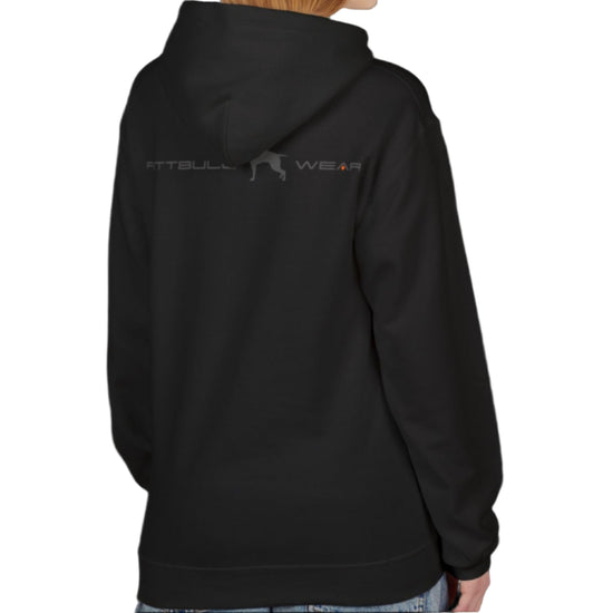 A woman wear sports black hoodet, fitness sweatshirt Fitbull, with motivation desighn Unleash The Beast, back view.