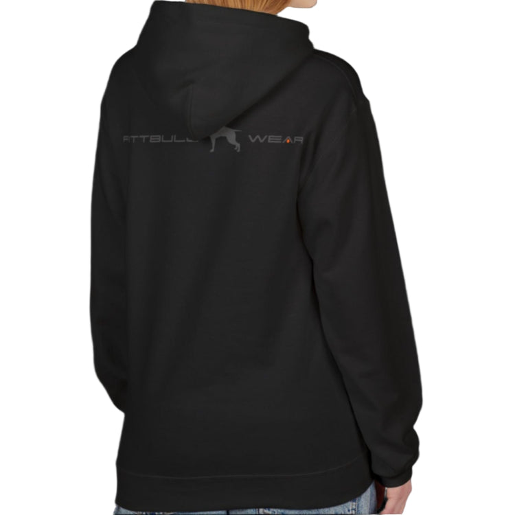 A woman wear sports black hoodet, fitness sweatshirt Fitbull, with motivation desighn Unleash The Beast, back view.