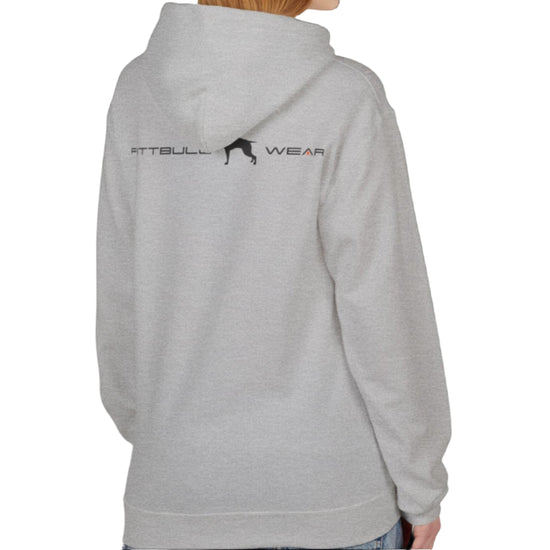 A woman wear sports silver grey hoodet, fitness sweatshirt Fitbull, with motivation desighn Unleash The Beast, back view.
