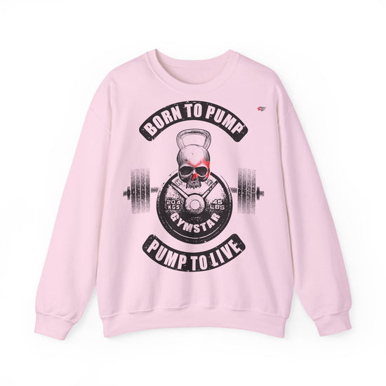 A light pink crewneck sweatshirt featuring a gym-themed graphic print on the front with a skull, kettlebell, barbell, and the text 'BORN TO PUMP' and 'PUMP TO LIVE'.