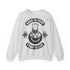 A light heather gray crewneck sweatshirt featuring a gym-themed graphic print on the front with a skull, barbell, and the text 'BORN TO PUMP' and 'PUMP TO LIVE'.