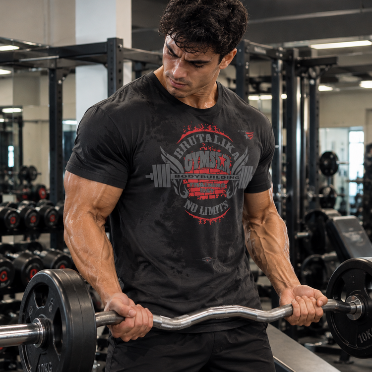 Luca Moretti wearing a black GYMSTAR Brutalika bodybuilding graphic T-shirt while performing EZ-bar biceps curls.