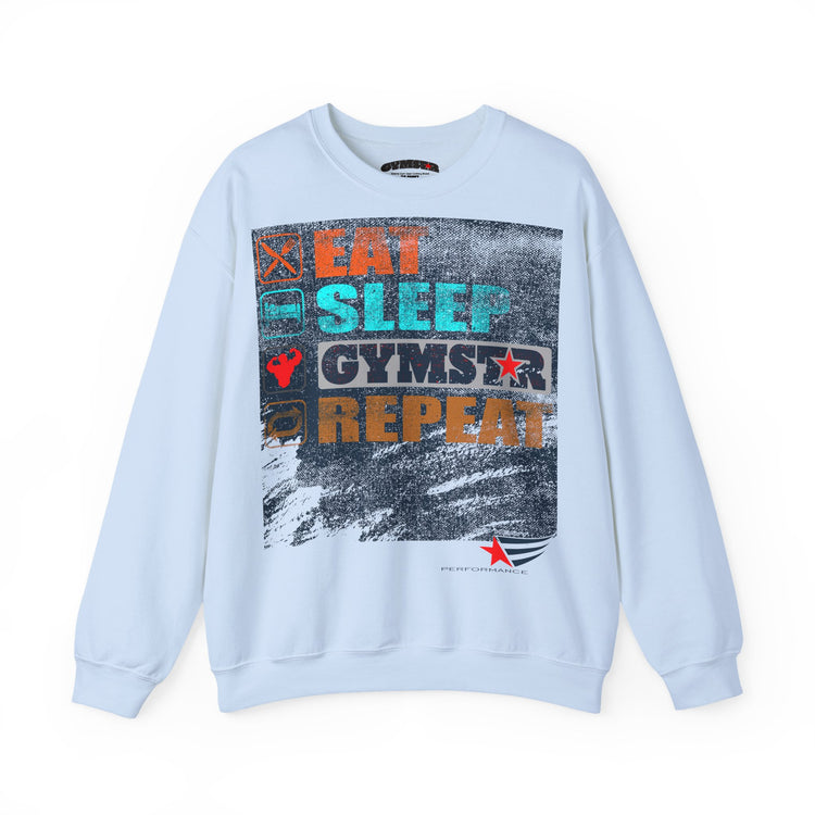 A light blue crewneck sweatshirt featuring a large graphic print on the front with the words 'EAT SLEEP GYMSTAR REPEAT' in various colors over a distressed gray background.