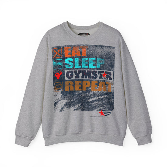 A heather gray crewneck sweatshirt featuring a large graphic print on the front with the words 'EAT SLEEP GYMSTAR REPEAT' in orange, teal, and white, alongside small fitness-themed icons.