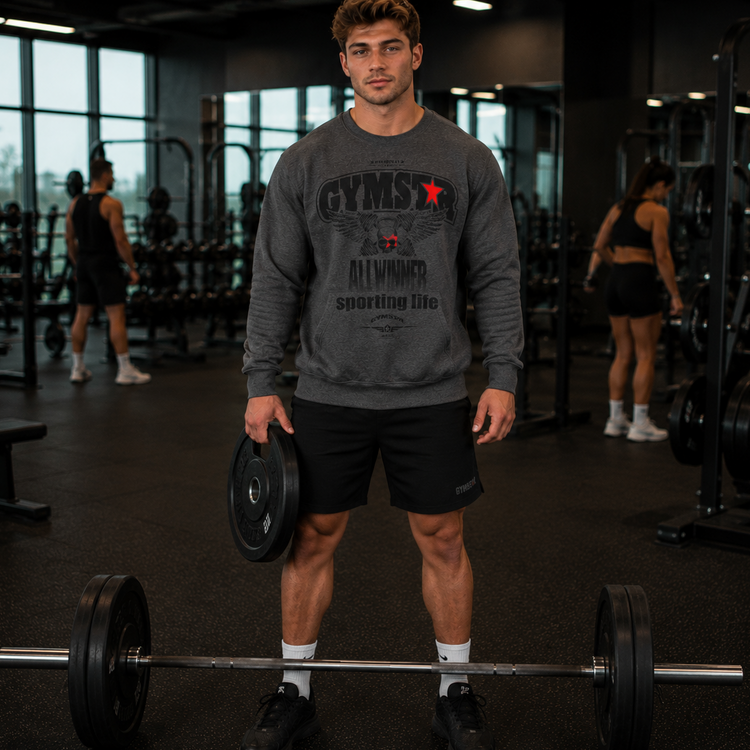 Man holding a barbell in a gym wearing a GYMSTAR sweatshirt.