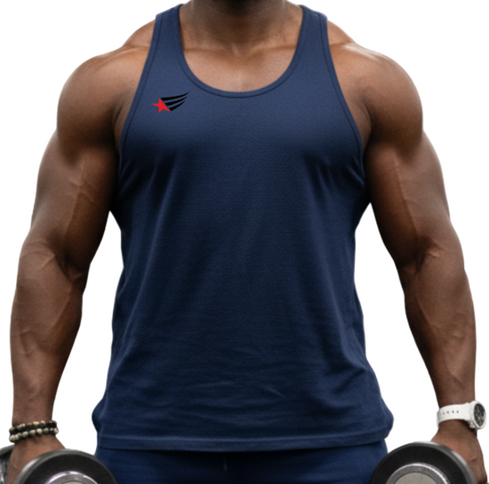 Man in a gym wearing a navy Gymstar fitness tank top and shorts, holding dumbbells.