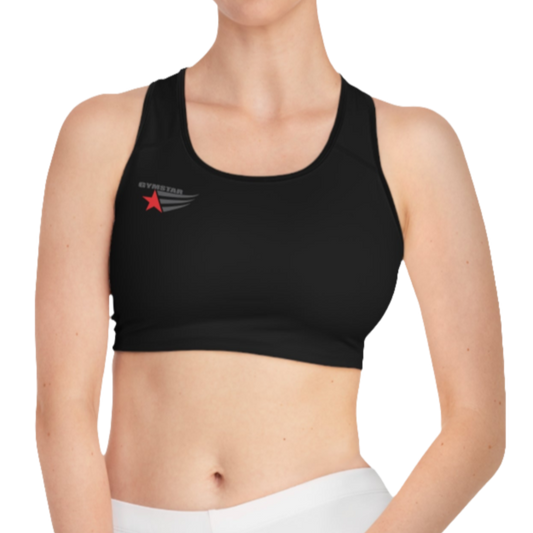 A women's solid black athletic sports bra Gymsatr. It features black trim around the neckline and armholes. A logo with a red star and three black stripes is on the left side of the chest, with the text "GO HEAVY" above it.
