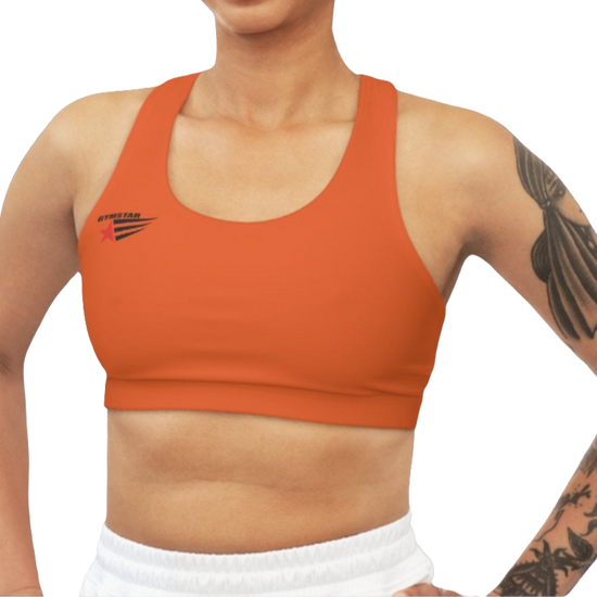 A woman wearing Orange,  sports, fitness bra from the Gimstar brand, with  a small logo on the left side. Front view.