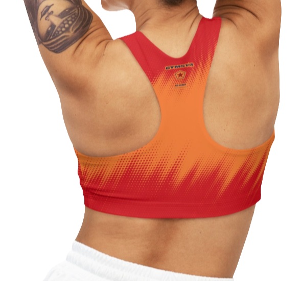 A women's athletic sports bra Gymstar, shown from the back. It features a red and orange color scheme with a dotted, gradient pattern radiating from the bottom. The straps are solid red and form a racerback style. The brand's logo, a red star within a circle of smaller stars, is printed on the upper back, along with the "GYMSTAR" brand name.