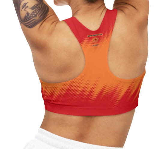 A women's athletic sports bra Gymstar, shown from the back. It features a red and orange color scheme with a dotted, gradient pattern radiating from the bottom. The straps are solid red and form a racerback style. The brand's logo, a red star within a circle of smaller stars, is printed on the upper back, along with the "GYMSTAR" brand name.