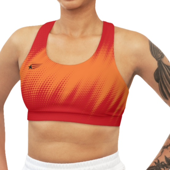 A women's athletic sports bra. It is primarily red with a orange, dotted, gradient pattern that radiates from the sides and bottom. The straps are solid red. A small logo featuring a star and three red and blue stripes is on the left side of the chest.
