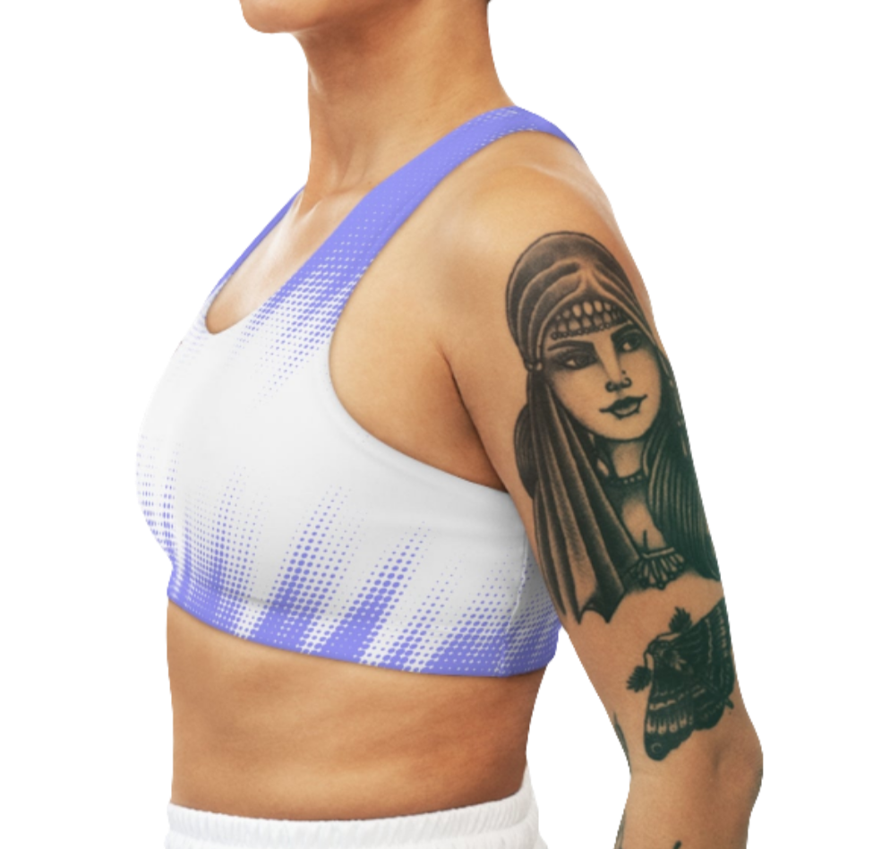 A women's athletic sports bra. It is primarily white with a blue, dotted, gradient pattern that radiates from the sides and bottom. The straps are solid blue. Left side view.