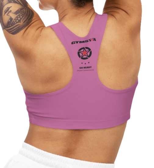 A person wearing a purple Gymstar sports bra from behind, with the brand's logo and a slogan 'GO HEAVY' visible on the back.