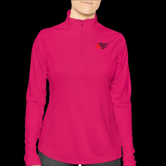 A person wearing a purple half-zip sweatshirt with  logo printed on the front.