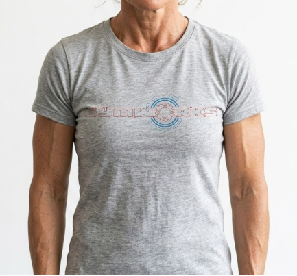 Person wearing a gray Gymworks t-shirt with a logo on a white background