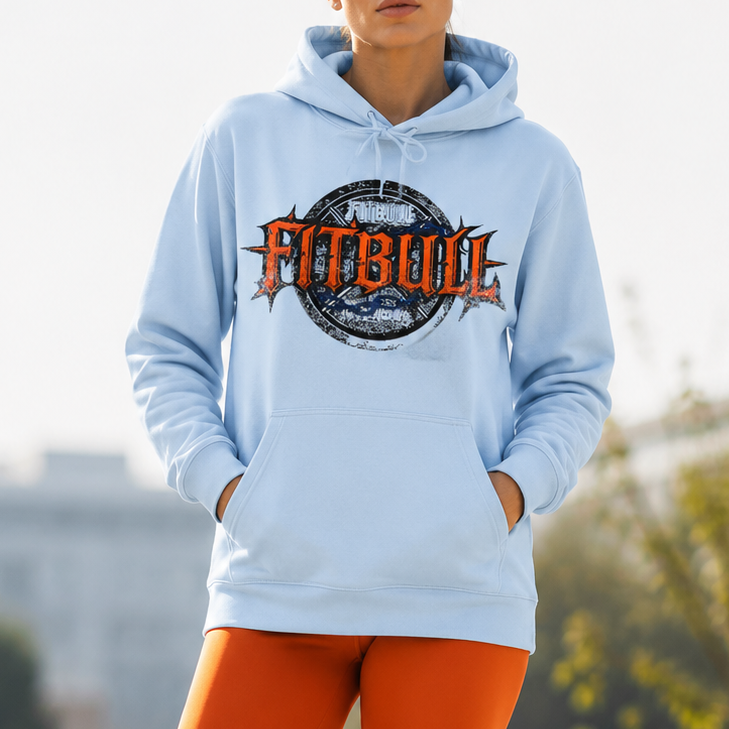 Person wearing a light blue hoodie with 'Fitbull' logo and orange leggings outdoors.