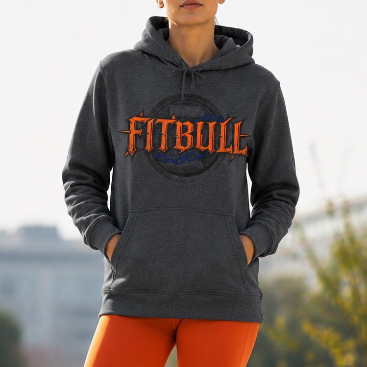 Person wearing a gray hoodie with 'FITBULL' logo, orange leggings, and blue sneakers outdoors.