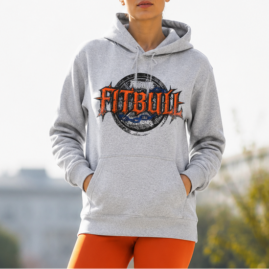 Person wearing a gray hoodie with 'FitBull' logo and orange leggings outdoors.