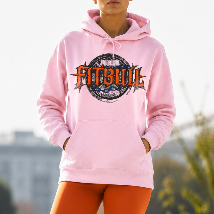 Woman wearing a pink hoodie with 'Fitbull' logo and orange leggings outdoors.