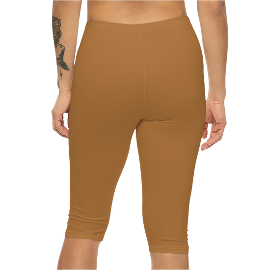 A woman wearing pair of brown Gymstar fitness leggings with a small logo on the left thigh area, designed for women. Rear, close up view.