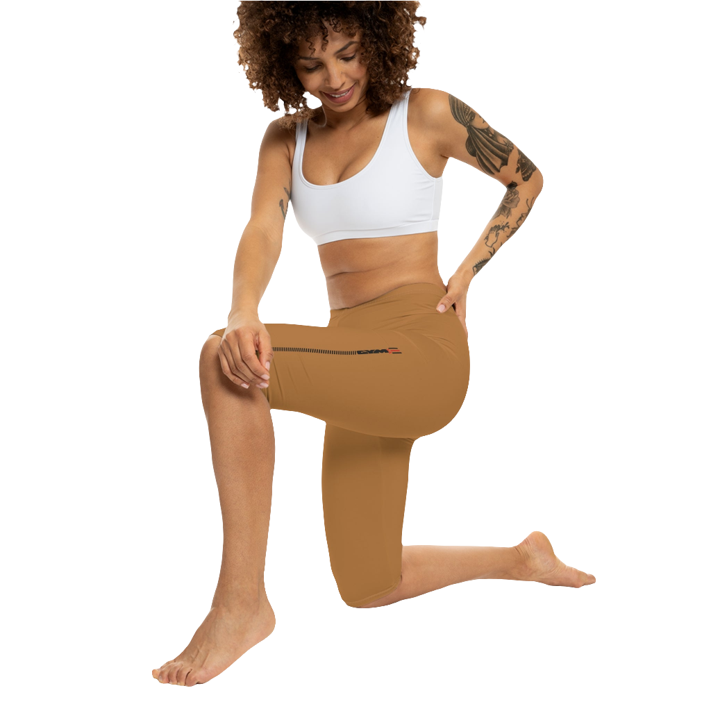 A woman wearing pair of brown Gymstar fitness leggings with a small logo on the left thigh area, designed for women. Front action  view.