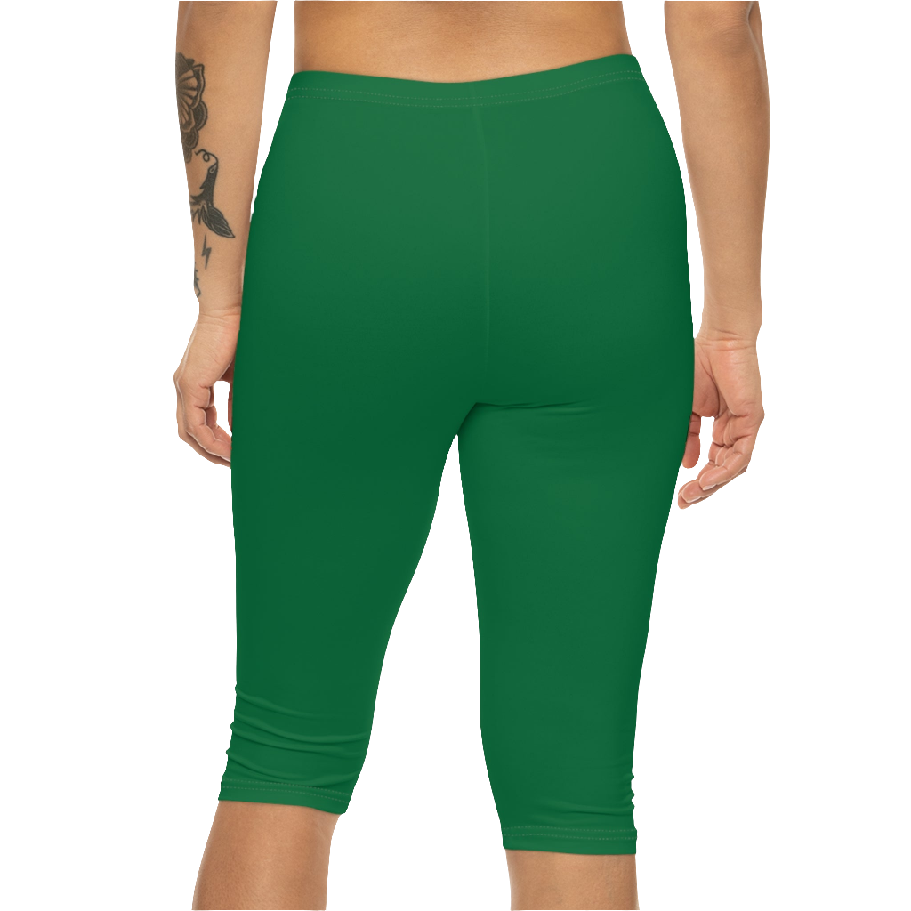 A woman wearing green high-waisted fitness leggings Gymstar with a logo on the waistband, paired with white sneakers. Rear  view.