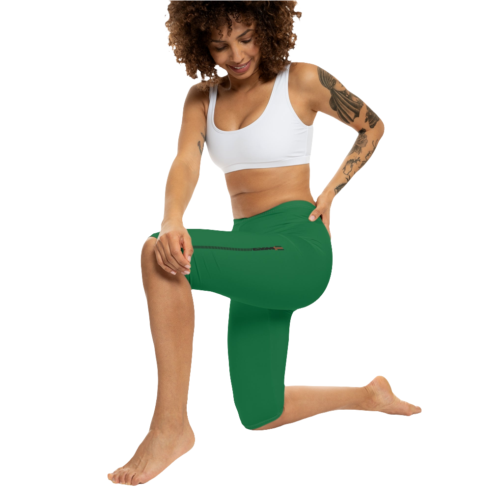 A woman wearing green high-waisted fitness leggings Gymstar with a logo on the waistband, paired with white sneakers. Action front view.