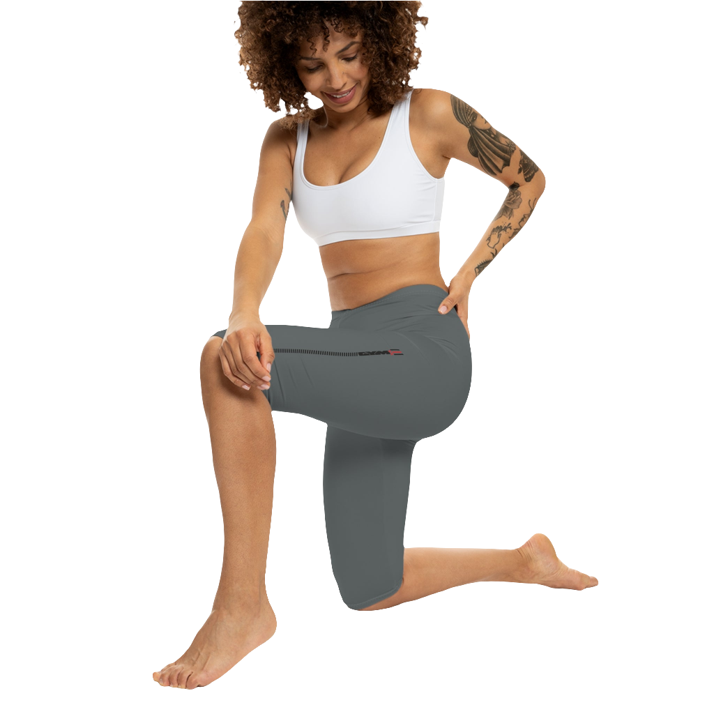 A woman wearing pair of gray Gymstar brand fitness leggings featuring a mid-rise waist and a logo, designed for yoga and other workouts. Front action view.