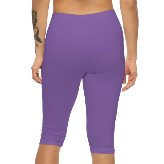 A woman wearing pair of purple fitness Gymstar leggings with a small logo on the upper left thigh area, designed for women's workouts. Rear close up view.