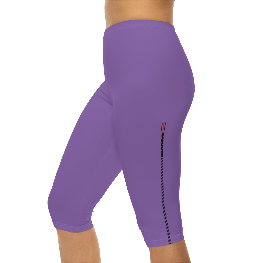 A woman wearing pair of purple fitness Gymstar leggings with a small logo on the upper left thigh area, designed for women's workouts. Left side close up view.