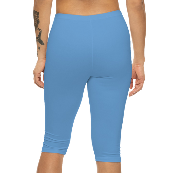 A woman wearing pair of blue fitness Gymstar leggings with a small logo on the upper left thigh area, designed for women's workouts. Rear close up view.