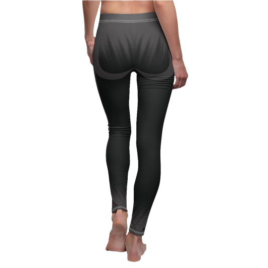 A female fitness model wearing pair of black Gymstar women's fitness leggings with capri cut, featuring white seam stitching and a mid-rise waist and art design.  Rear close up view.   