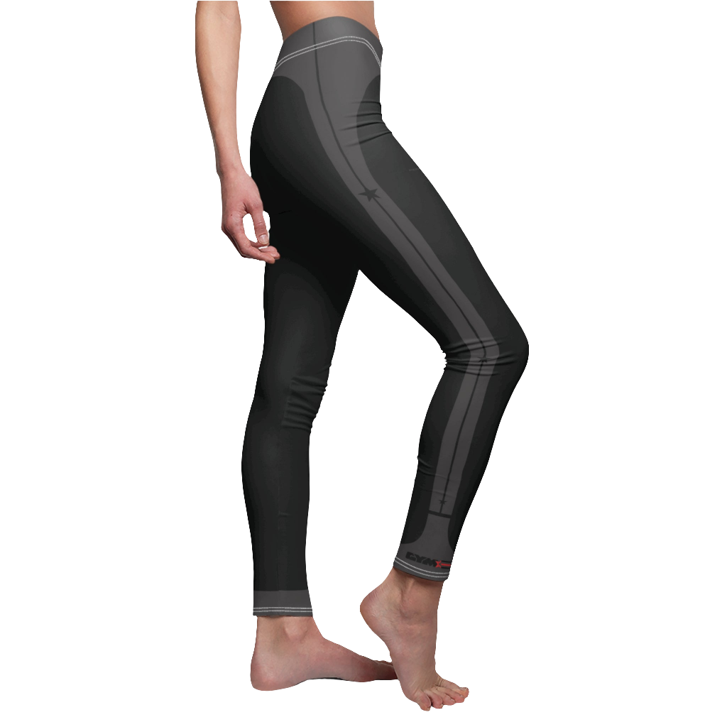 A female fitness model wearing pair of black Gymstar women's fitness leggings with capri cut, featuring white seam stitching and a mid-rise waist and gym art design.  Right side close up view.   