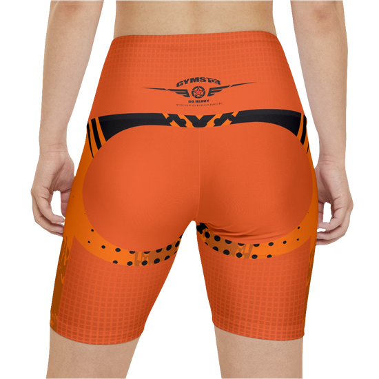 A female fitness model wearing a pair of orange Gymstar workout shorts with black stitching and a Gymstar logo on the upper left thigh area. Rear close up view. 