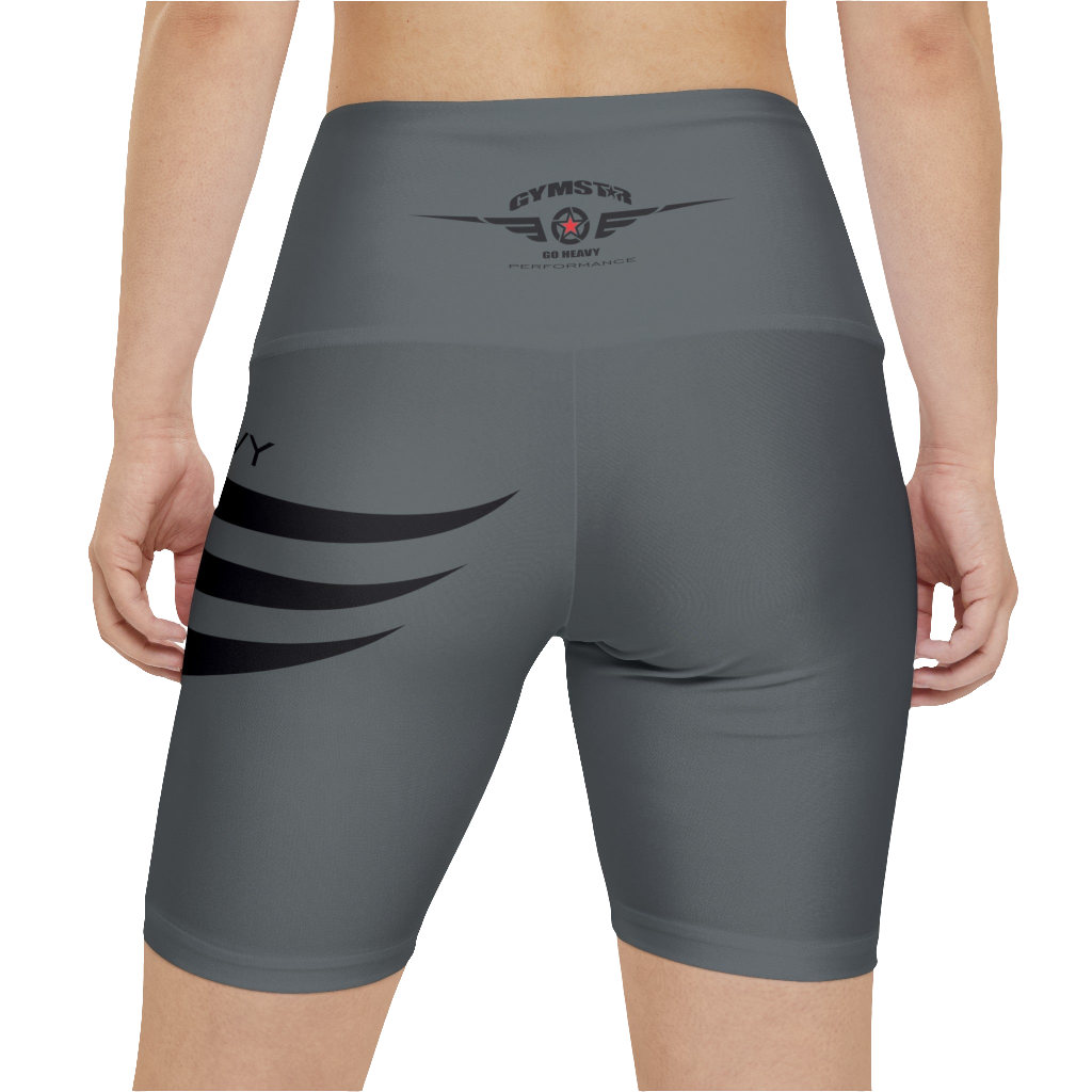 A woman wearings pair of green fitness leggings with a red star and 'GYMSTAR' logo on the upper left leg, waistband, and a 'GO HEAVY' text on the right side of the waistband. Rear close up view.