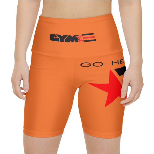 A woman wearings pair of orange Gymstar women's workout leggings with 'GYMSTAR' and 'GO HEAVY' text, along with a star graphic, on a person mid-section view. front close up view.