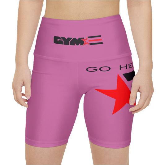 A womanwearings pair of pink women's workout leggings with a logo on the left thigh and the text 'GO HEAVY' on the right thigh. The leggings are designed to be skinny fit and have a mid-rise waist. Front close up view.
