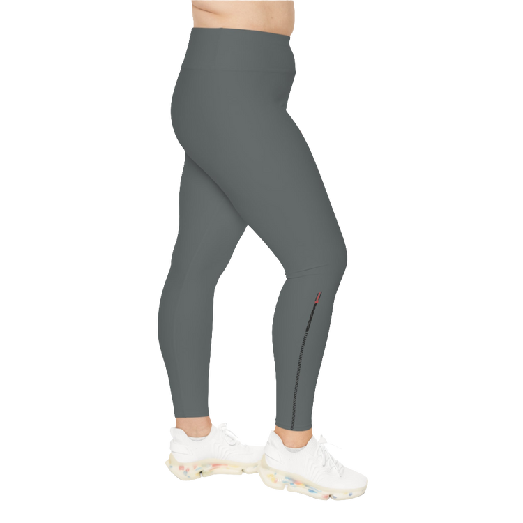 A woman wearing pair of grey high-waisted Gymstar fitness leggings with a logo on the upper left thigh, paired with white sneakers. Left side view.