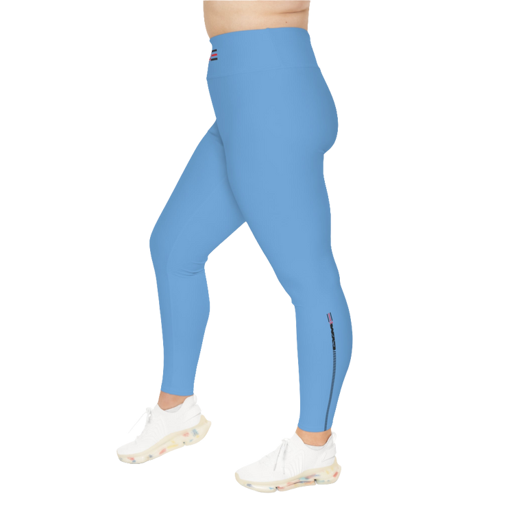 A woman wearing blue high-waisted fitness leggings with a Gymstar logo on the waistband, standing upright with a neutral expression. Right isde view.