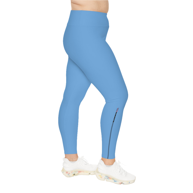 A woman wearing blue high-waisted fitness leggings with a Gymstar logo on the waistband, standing upright with a neutral expression. Left side view.