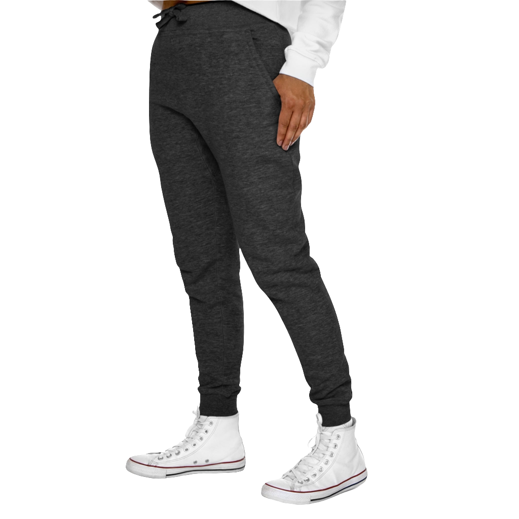 A person standing sideways, wearing gray joggers and white sneakers. The joggers have a ribbed bottom and waistband cuffs, and feature two side pockets and a back pocket.
